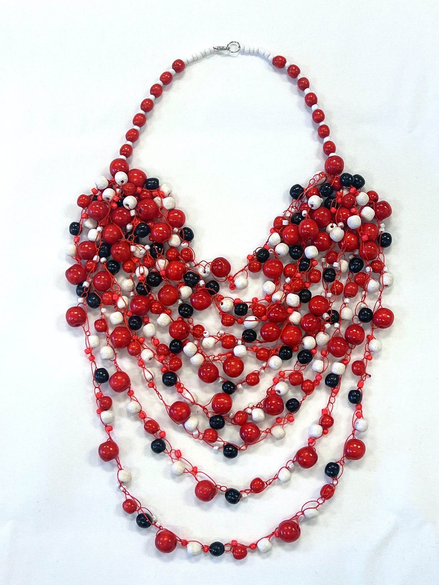 Artisan crafted woven glass and wood bead necklace. Red, white, black